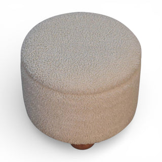 Round ottoman with textured surface on a white background