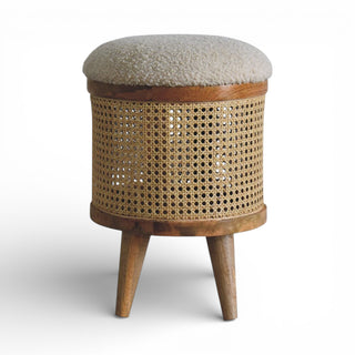 Wooden stool with woven design and textured cushion on a white background