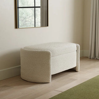 Ivory boucle storage ottoman in minimalist room with wood flooring