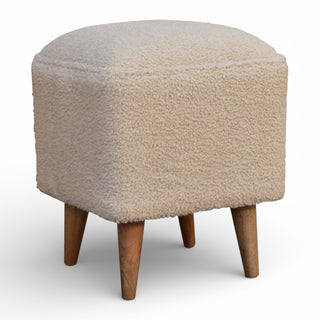 Beige textured ottoman with wooden legs on a white background