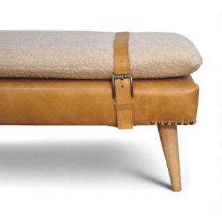 Close-up of a bench with beige cushion and brown leather strap on a white background