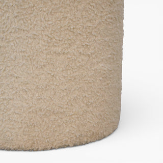 Close-up of a textured beige carpet corner on a white background