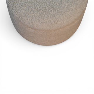 Round ceramic object with textured surface on a white background