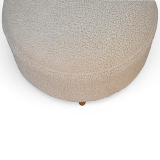 Round textured ottoman on a white background