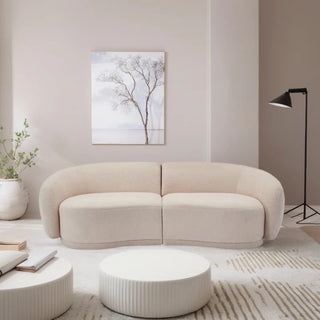 Cream boucle loveseat in elegant interior with coffee table and minimal decor