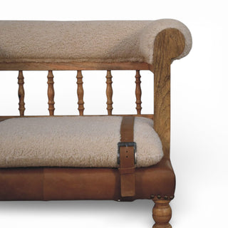 Wooden bench with sheepskin seat and backrest on a white background