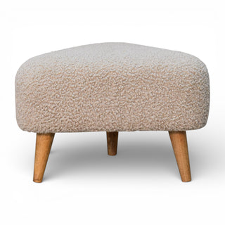 Round ottoman with textured beige cushion and wooden legs on a white background