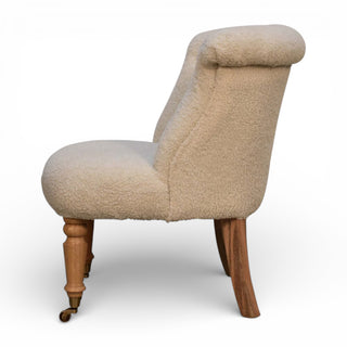 Beige upholstered chair with wooden legs on a white background