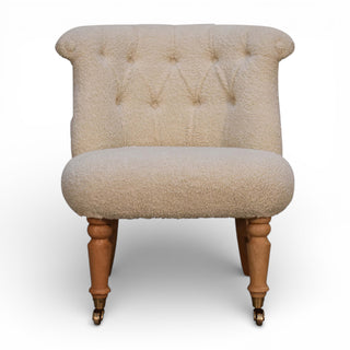 Beige upholstered chair with wooden legs on a white background