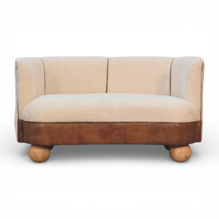 Small beige and brown sofa with wooden legs on a white background