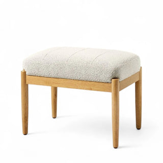 White boucle ottoman with wooden legs shown from front angle