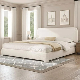 Cream white boucle upholstered bed frame with architectural wall moldings and neutral decor