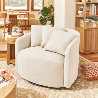 White boucle swivel chair in living room setting with wooden furniture and decor