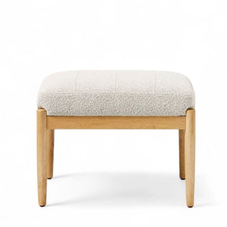 Side view of white boucle ottoman showing clean rectangular design and wooden legs