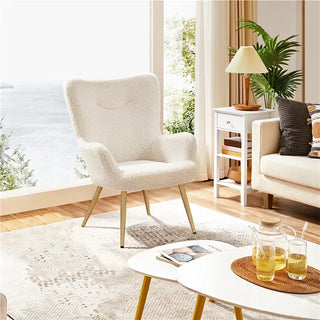 Ivory boucle wingback chair in a sunlit living area with wooden coffee table, area rug, and large windows