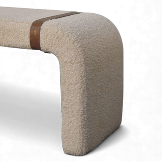 End view of the Bouclé Bench Cream Leather Strap showing the solid block-like side and continuous bouclé upholstery.

