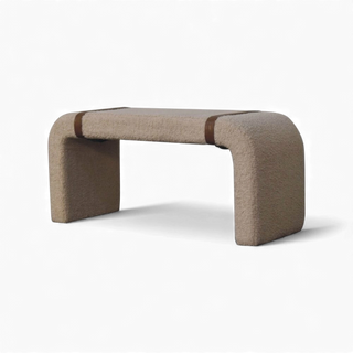 Side view of the Bouclé Bench Cream Leather Strap highlighting the arched leg design and leather strap detail across the seat.

