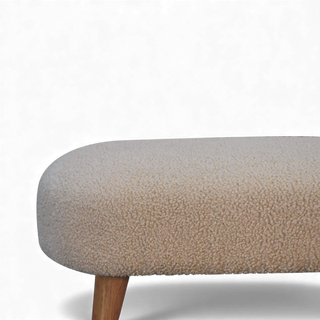 Side view of the Bouclé Bench Cream Nordic Hallway from the left side displaying the slim oval seat profile and two wooden legs.

