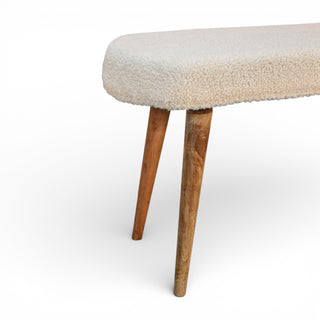Diagonal view of Bouclé Bench with natural mango wood legs and soft cream Bouclé upholstery

