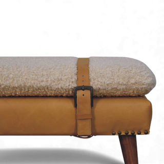 Side close-up of the Bouclé Bench Cream Tan Leather X-Strap highlighting the cream bouclé seat, tan leather wrap, and vertical strap with buckle.

