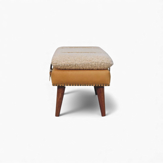 Side view of the Bouclé Bench Cream Tan Leather X-Strap showing the slim profile, leather-wrapped base, and tapered wooden legs.

