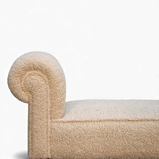 Side close-up of the Bouclé Bench Cream Turned-Leg Classic focusing on the rounded armrest and textured cream bouclé fabric.