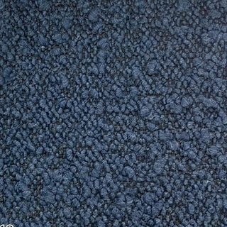 Close-up of navy tweed fabric showing rich textured surface with subtle flecks.