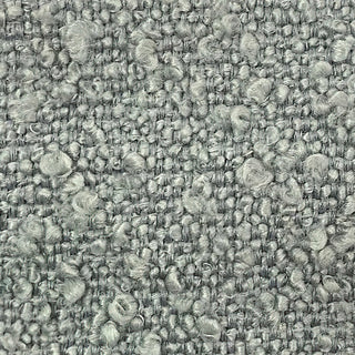 Close-up of sage tweed fabric showing textured weave with light and dark speckles.