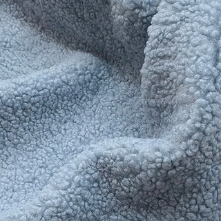 Close-up of sky blue teddy fabric showing soft, plush texture with gentle folds.